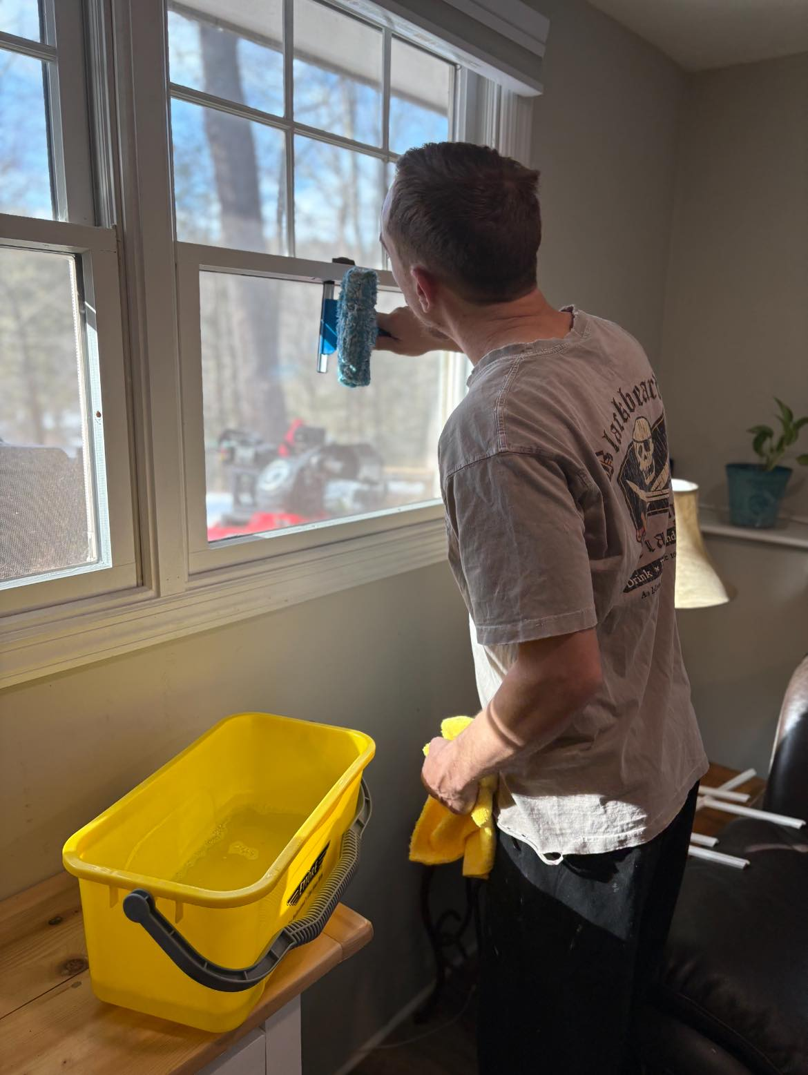 Interior window cleaning with professional squeegee technique