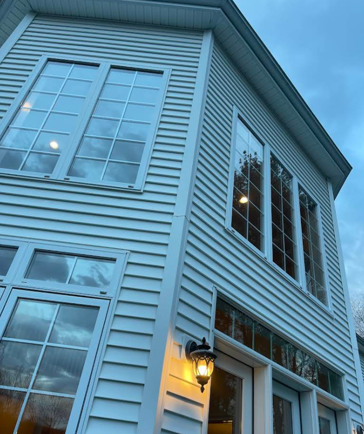 Multi-story home with sparkling clean windows at dusk